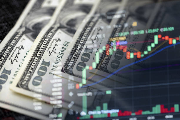 Dollar Dips, Stocks Slide Amid Diminished Rate Cut Expectations